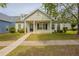Charming single-Gathering home with a manicured front yard and inviting front porch at 6053 Park Close, Fairburn, GA 30213