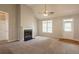 Spacious living room featuring high ceilings, a fireplace, neutral carpet, and abundant natural light at 6053 Park Close, Fairburn, GA 30213