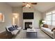 Inviting living room boasts a fireplace, a ceiling fan, cozy furniture, and view to the exterior at 6053 Park Close, Fairburn, GA 30213