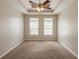 Cozy main bedroom features tray ceilings, recessed lighting, and natural light from the windows at 6053 Park Close, Fairburn, GA 30213