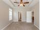 Inviting main bedroom with tray ceilings, ample natural light, and access to multiple doorways at 6053 Park Close, Fairburn, GA 30213