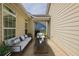 Covered patio area staged with modern outdoor furniture at 6053 Park Close, Fairburn, GA 30213