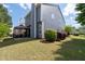 View of backyard features a covered patio with lush green grass and blue siding at 2341 Lily Valley Dr, Lawrenceville, GA 30045