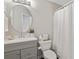 Bright bathroom features a round mirror, white countertop, and a toilet with a shower curtain at 2341 Lily Valley Dr, Lawrenceville, GA 30045