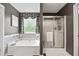Stylish bathroom features a soaking tub with tile surround and a glass-enclosed shower, creating a spa-like retreat at 2341 Lily Valley Dr, Lawrenceville, GA 30045