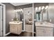 Dual vanities in the bathroom offer ample space and storage, enhanced by dark wood floors and neutral walls at 2341 Lily Valley Dr, Lawrenceville, GA 30045