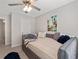 Comfortable bedroom features a daybed, carpet, ceiling fan, and natural light from the window at 2341 Lily Valley Dr, Lawrenceville, GA 30045