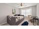 Comfortable bedroom features a daybed, carpet, ceiling fan, and natural light from the window at 2341 Lily Valley Dr, Lawrenceville, GA 30045