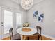 Cozy breakfast nook with round table, modern chandelier, and glass panel exterior door at 2341 Lily Valley Dr, Lawrenceville, GA 30045