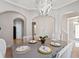 Charming dining room with a modern chandelier, archways, and seating for six at 2341 Lily Valley Dr, Lawrenceville, GA 30045