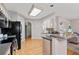 Bright kitchen with modern appliances, light wood cabinets, and hardwood floors at 2341 Lily Valley Dr, Lawrenceville, GA 30045