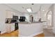 Well-lit kitchen featuring modern black appliances, wood floors, and dark countertops at 2341 Lily Valley Dr, Lawrenceville, GA 30045