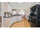 Well-lit kitchen with light cabinets, stainless steel appliances, and hardwood floors at 2341 Lily Valley Dr, Lawrenceville, GA 30045