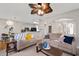 Open concept living room with hardwood floors, comfortable seating, and kitchen view at 2341 Lily Valley Dr, Lawrenceville, GA 30045
