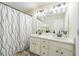 Bright bathroom with a double vanity, modern lighting, and a stylish shower curtain at 285 Enterprise Path, Hiram, GA 30141