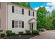 Traditional two-story townhome with black shutters, covered entry, and manicured shrubs at 285 Enterprise Path, Hiram, GA 30141