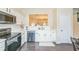 This kitchen has stainless appliances, white cabinets, and dark wood floors at 285 Enterprise Path, Hiram, GA 30141