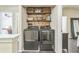 Charming laundry nook with modern washer and dryer set and stylish wood plank backsplash at 285 Enterprise Path, Hiram, GA 30141