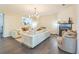 Inviting living room with a fireplace, modern light fixture, and a comfortable, neutral-toned sectional sofa at 285 Enterprise Path, Hiram, GA 30141