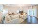 Open-concept living room boasts a fireplace, modern lighting, and a comfortable sectional sofa at 285 Enterprise Path, Hiram, GA 30141