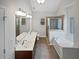 Bright bathroom featuring a double vanity, soaking tub, and glass-enclosed shower at 403 Vinings Vintage Cir, Mableton, GA 30126