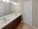 Bathroom featuring double sinks, large mirror, and brown cabinets at 403 Vinings Vintage Cir, Mableton, GA 30126