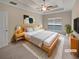Cozy bedroom with a tray ceiling, ceiling fan, and a comfortable queen-sized bed at 403 Vinings Vintage Cir, Mableton, GA 30126
