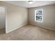 Clean, neutral bedroom with a window providing natural light and carpeted floor at 403 Vinings Vintage Cir, Mableton, GA 30126