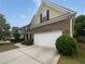 Brick-sided home with an attached garage and an extended driveway at 403 Vinings Vintage Cir, Mableton, GA 30126