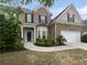 Charming home with a brick facade, landscaped front yard, and attached garage at 403 Vinings Vintage Cir, Mableton, GA 30126