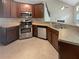 Kitchen with granite countertops, stainless steel appliances and brown cabinets at 403 Vinings Vintage Cir, Mableton, GA 30126