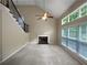 Open living room features high ceilings, a fireplace, and large windows for natural light at 403 Vinings Vintage Cir, Mableton, GA 30126