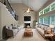 Bright living room with high ceilings, large windows, and a cozy fireplace at 403 Vinings Vintage Cir, Mableton, GA 30126
