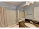 Bathroom with granite countertop sink, white shower and tub, and updated lighting at 6118 Queen Anne Ct, Norcross, GA 30093