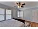 Comfortable bedroom featuring hard wood floors, ceiling fan and natural lighting at 6118 Queen Anne Ct, Norcross, GA 30093