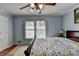 Bright bedroom with light blue walls, hardwood floors, and natural light at 6118 Queen Anne Ct, Norcross, GA 30093