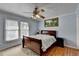 Charming bedroom featuring hardwood floors, and a ceiling fan for added comfort at 6118 Queen Anne Ct, Norcross, GA 30093