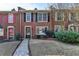 Beautiful brick townhome with classic design elements and well-maintained landscaping at 6118 Queen Anne Ct, Norcross, GA 30093
