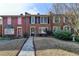 Attractive brick townhouse featuring colorful shutters and a well-cared-for lawn at 6118 Queen Anne Ct, Norcross, GA 30093