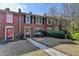 Attractive brick townhouse featuring colorful shutters and a well-cared-for lawn at 6118 Queen Anne Ct, Norcross, GA 30093