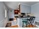 Eat-in kitchen with countertop seating, stainless appliances, dark wood cabinetry, and a door to the outside at 6118 Queen Anne Ct, Norcross, GA 30093