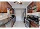 Modern kitchen with stainless steel appliances, granite countertops, and dark wood cabinetry at 6118 Queen Anne Ct, Norcross, GA 30093