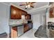 Kitchen with dark wood cabinetry, stainless steel appliances, and sleek black countertop at 6118 Queen Anne Ct, Norcross, GA 30093