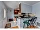 Eat-in kitchen with countertop seating, stainless appliances, and dark wood cabinetry at 6118 Queen Anne Ct, Norcross, GA 30093