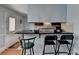 Eat-in kitchen featuring countertop seating, dark wood cabinetry, stainless appliances, and exterior door at 6118 Queen Anne Ct, Norcross, GA 30093