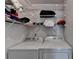 Functional laundry room with washer, dryer, and wire shelving for ample storage at 6118 Queen Anne Ct, Norcross, GA 30093