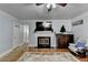 Cozy living room with fireplace, ceiling fan, and hardwood floors at 6118 Queen Anne Ct, Norcross, GA 30093