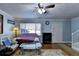 Bright living room with hardwood floors, ceiling fan, and staircase at 6118 Queen Anne Ct, Norcross, GA 30093
