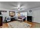 Comfortable living room with neutral walls, ceiling fan, hardwood floors, and a cozy seating arrangement at 6118 Queen Anne Ct, Norcross, GA 30093
