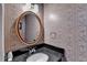 Elegant powder room with floral wallpaper, granite countertop, and stylish mirror at 6118 Queen Anne Ct, Norcross, GA 30093